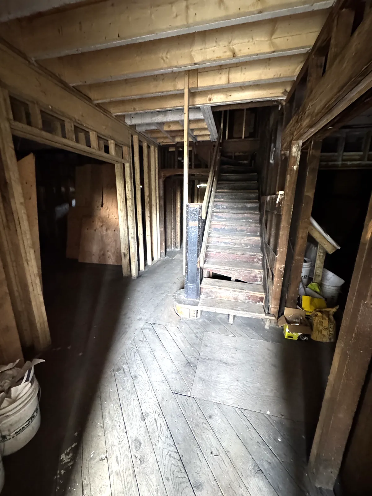Fire-damaged main stair and subfloor in a Vancouver heritage Craftsman