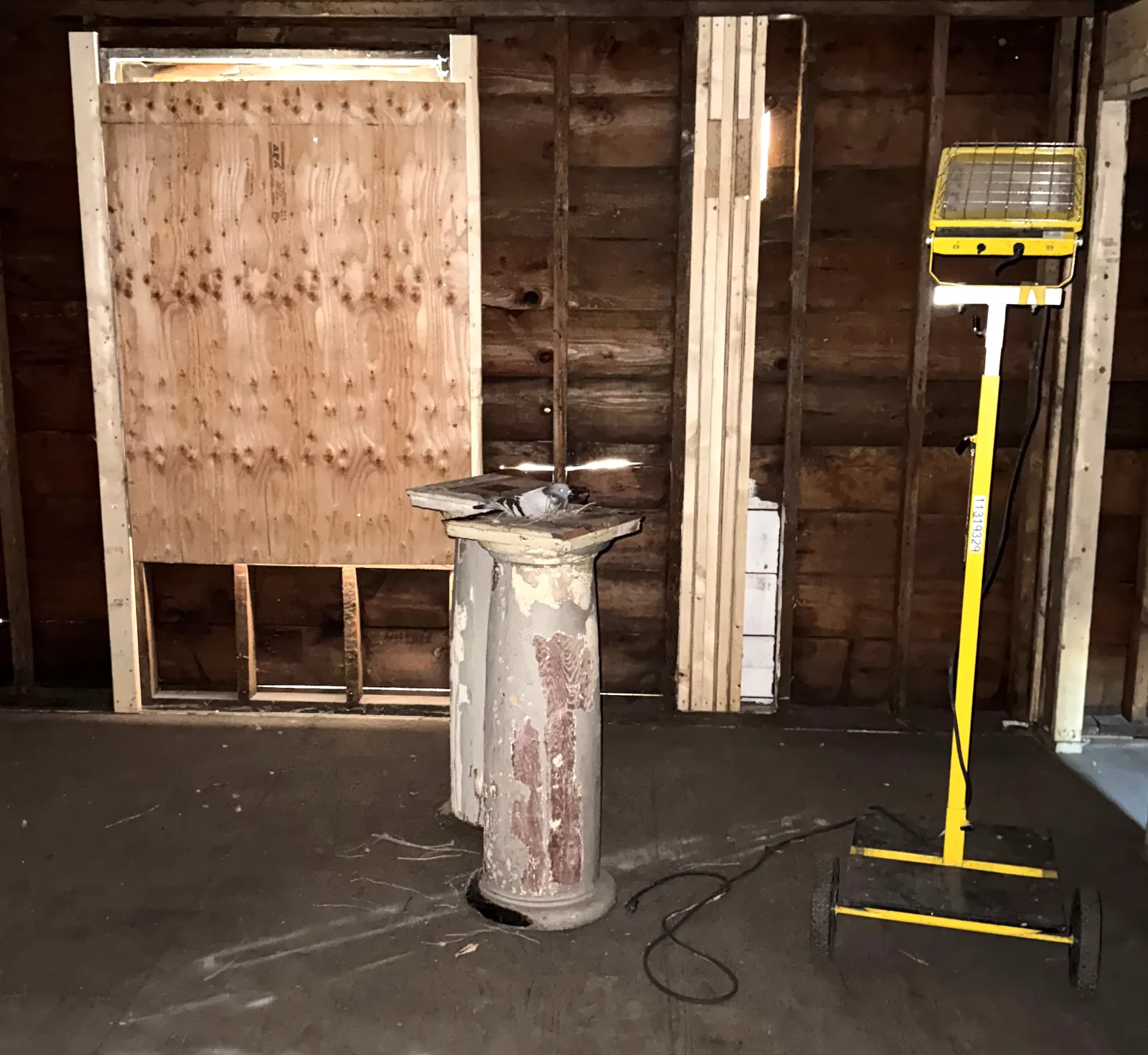 A salvaged original porch column, kept inside the house as the reference for new ones