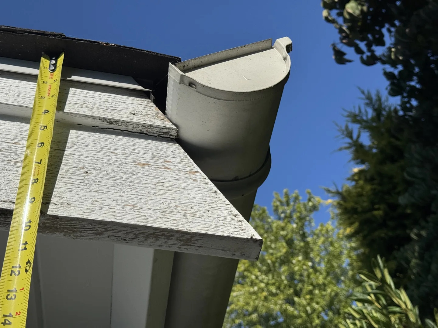 Measuring deteriorated fascia and gutter details during repair scoping, turning a depreciation-report line item into a defined scope