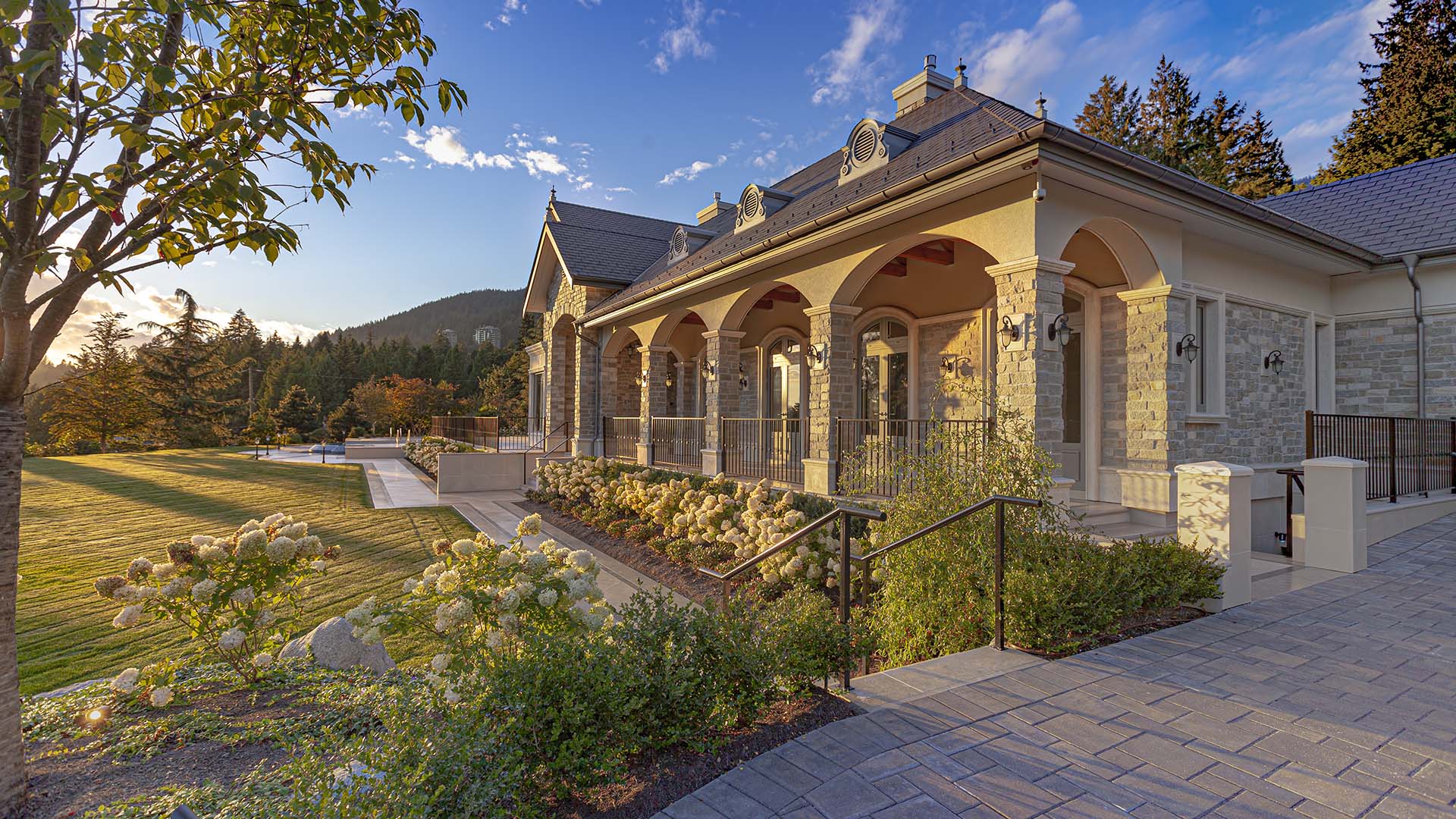 Altamont's Muse exterior detail with stone masonry and hydrangea landscaping in West Vancouver