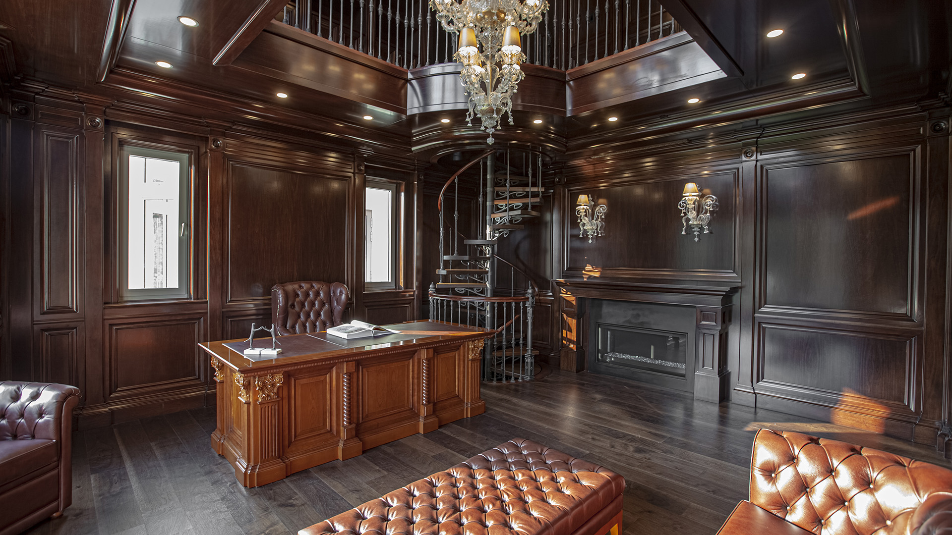 Altamont's Muse study with executive desk, fireplace and library above in West Vancouver