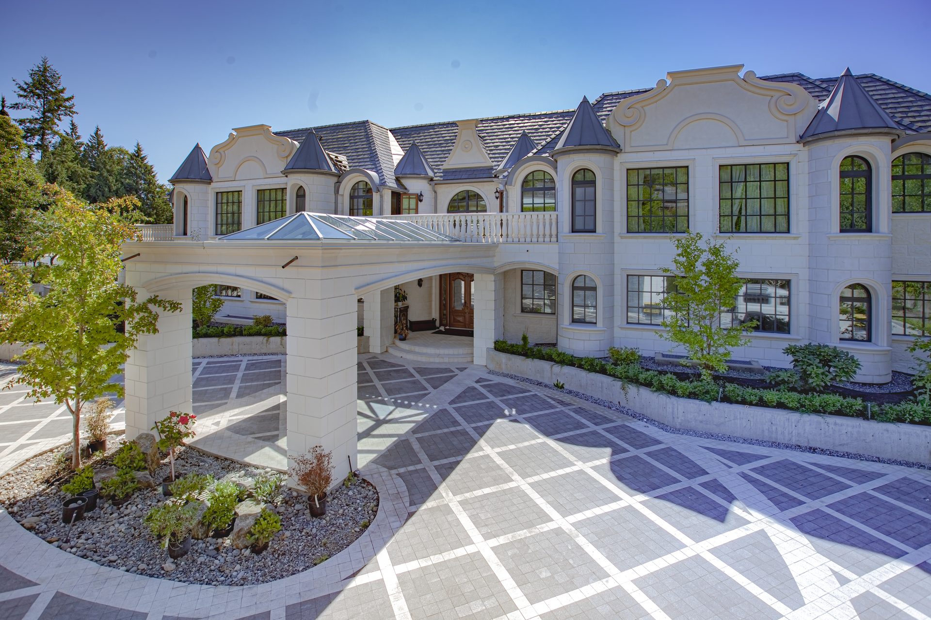 Ambleside Palace glass roofed porte cochere and main entrance with carved limestone facade in West Vancouver