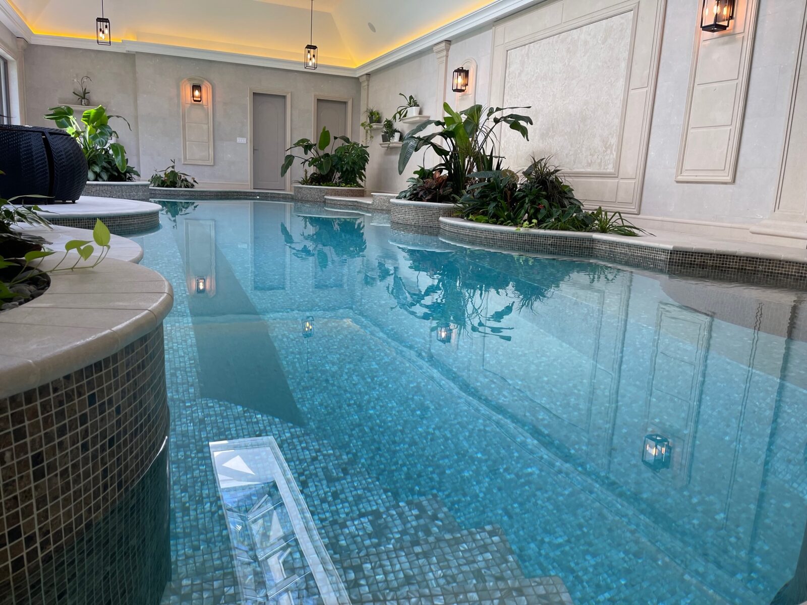 Mosaic tile indoor pool with underwater lighting in luxury West Vancouver home