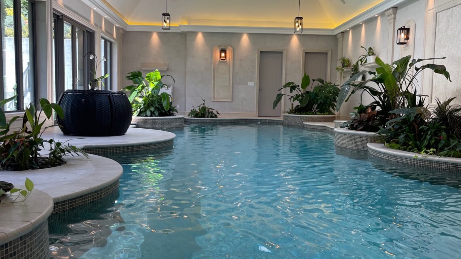 Indoor pool with skylight and tropical planters in West Vancouver estate