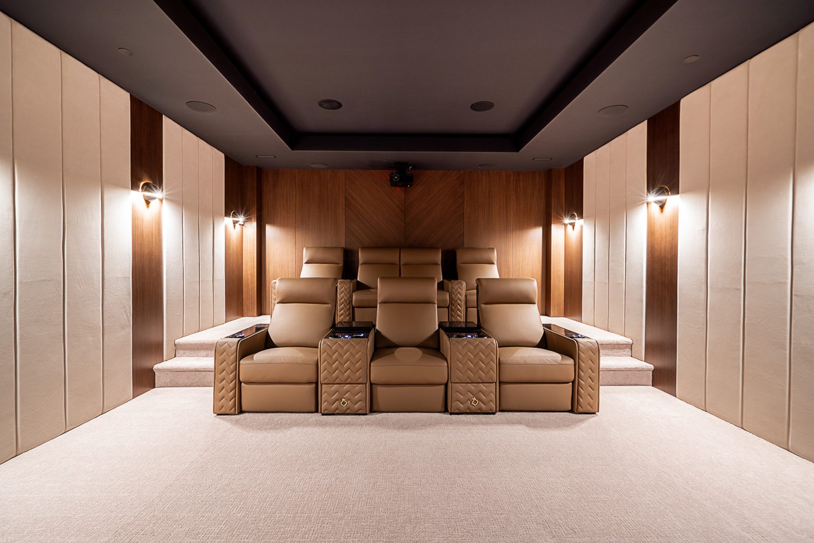 Home theater rear view showing two-row tiered seating and acoustic fabric panels The Butterfly West Vancouver