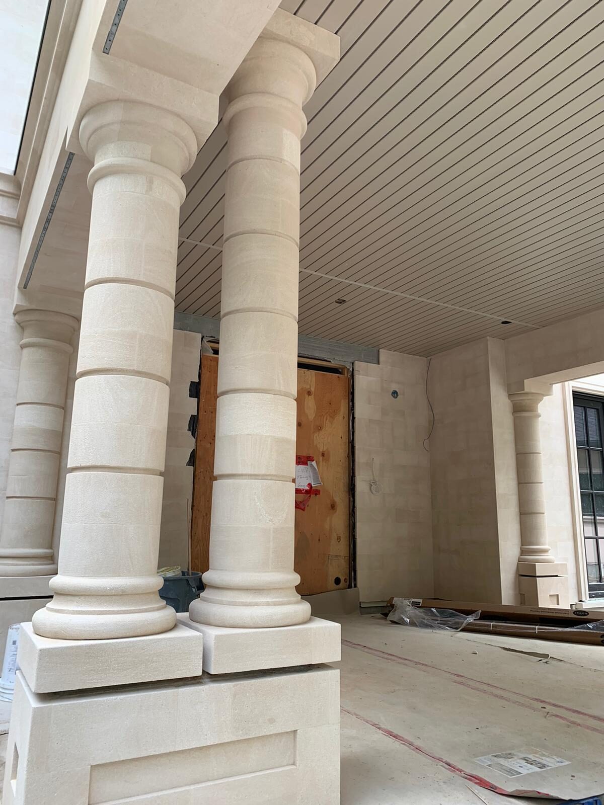 Sandstone Tuscan columns at the portico entrance