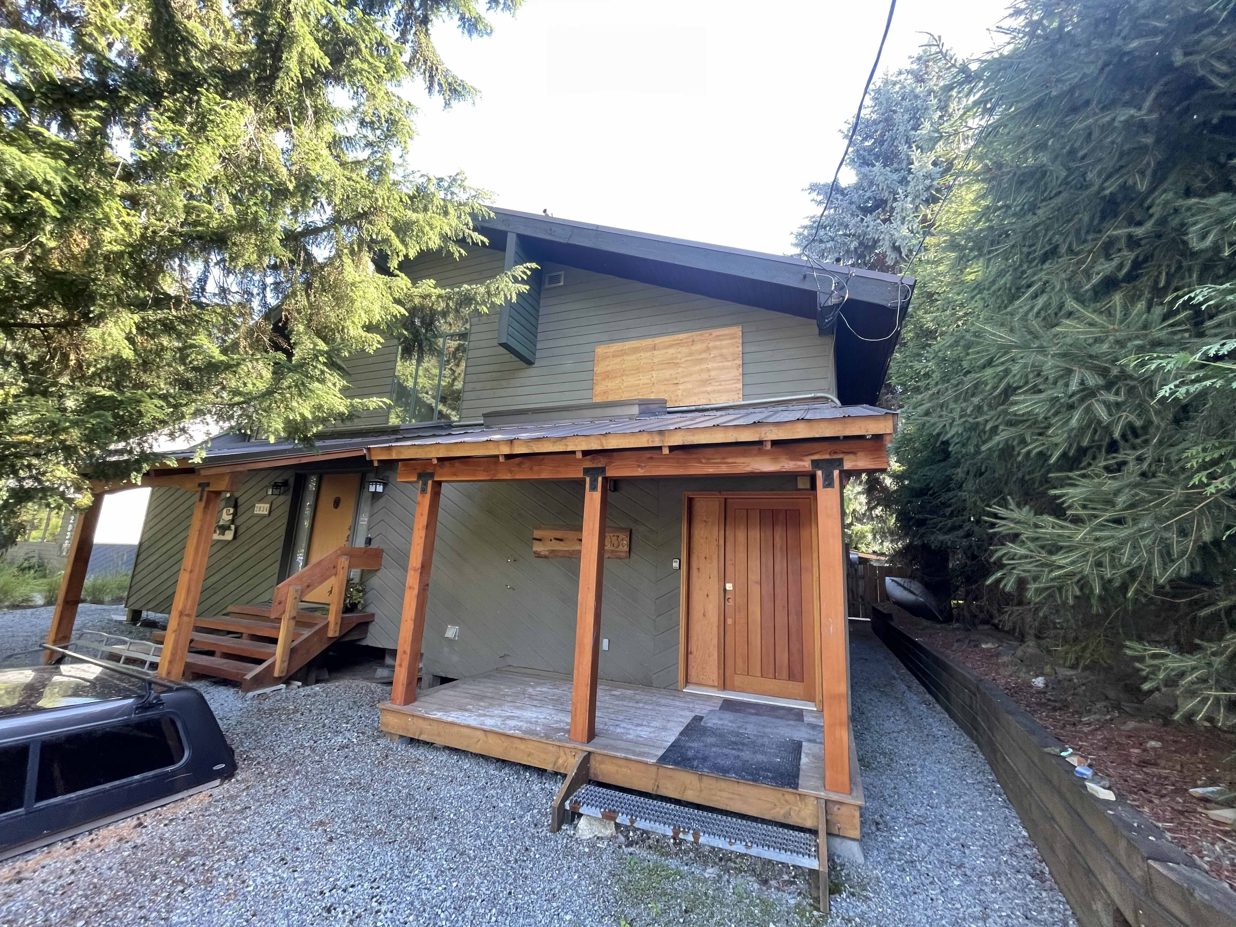 Fire-damaged home under reconstruction in Whistler — Eurohouse Construction insurance restoration project showing structural framing and exterior rebuild