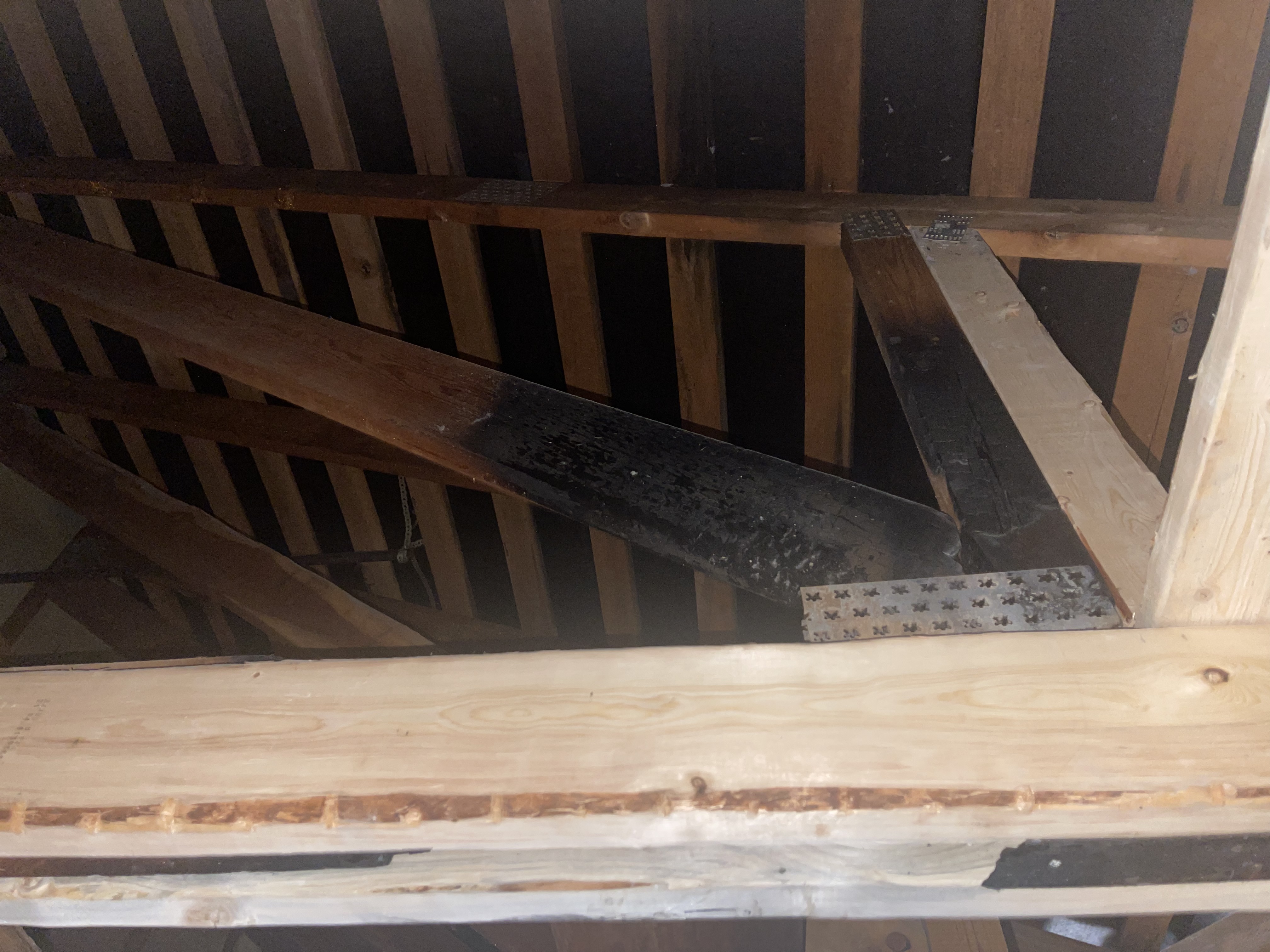 Construction crew performing structural framing repair after fire damage