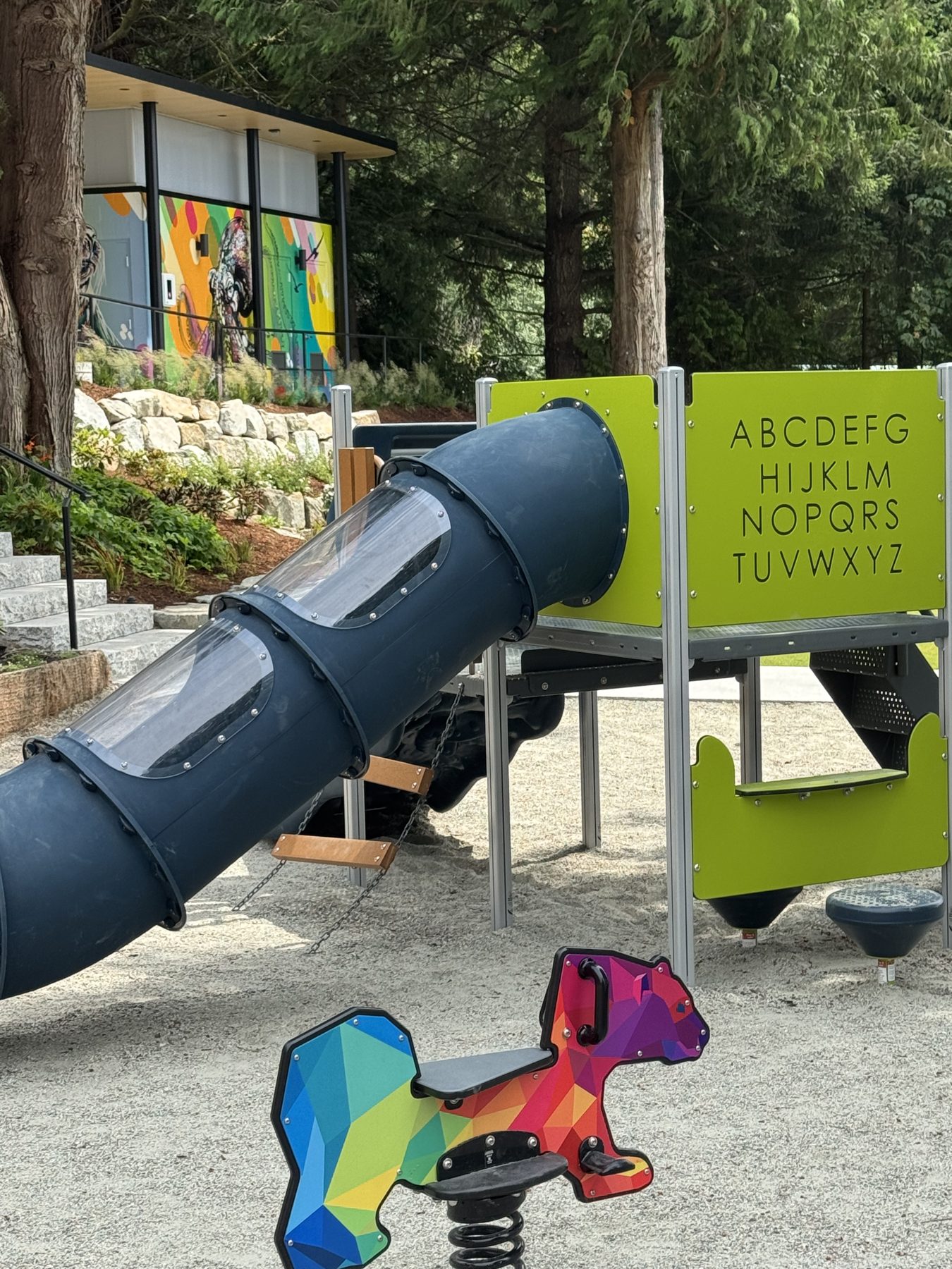 Playground equipment detail at Lions Bay Beach Park with slide and play panels
