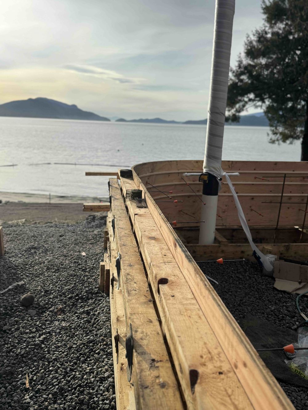Concrete formwork with rebar and Howe Sound sunset at Lions Bay Beach Park by Eurohouse Construction
