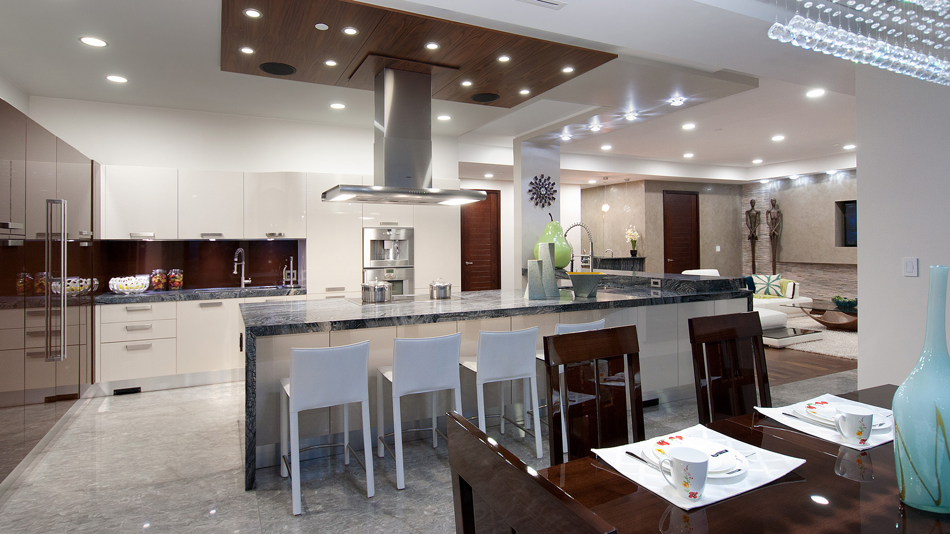 Gourmet kitchen with custom Italian high-gloss cabinets polished granite island bar seating German appliances walnut ceiling soffit and crystal lighting Millstream British Properties West Vancouver