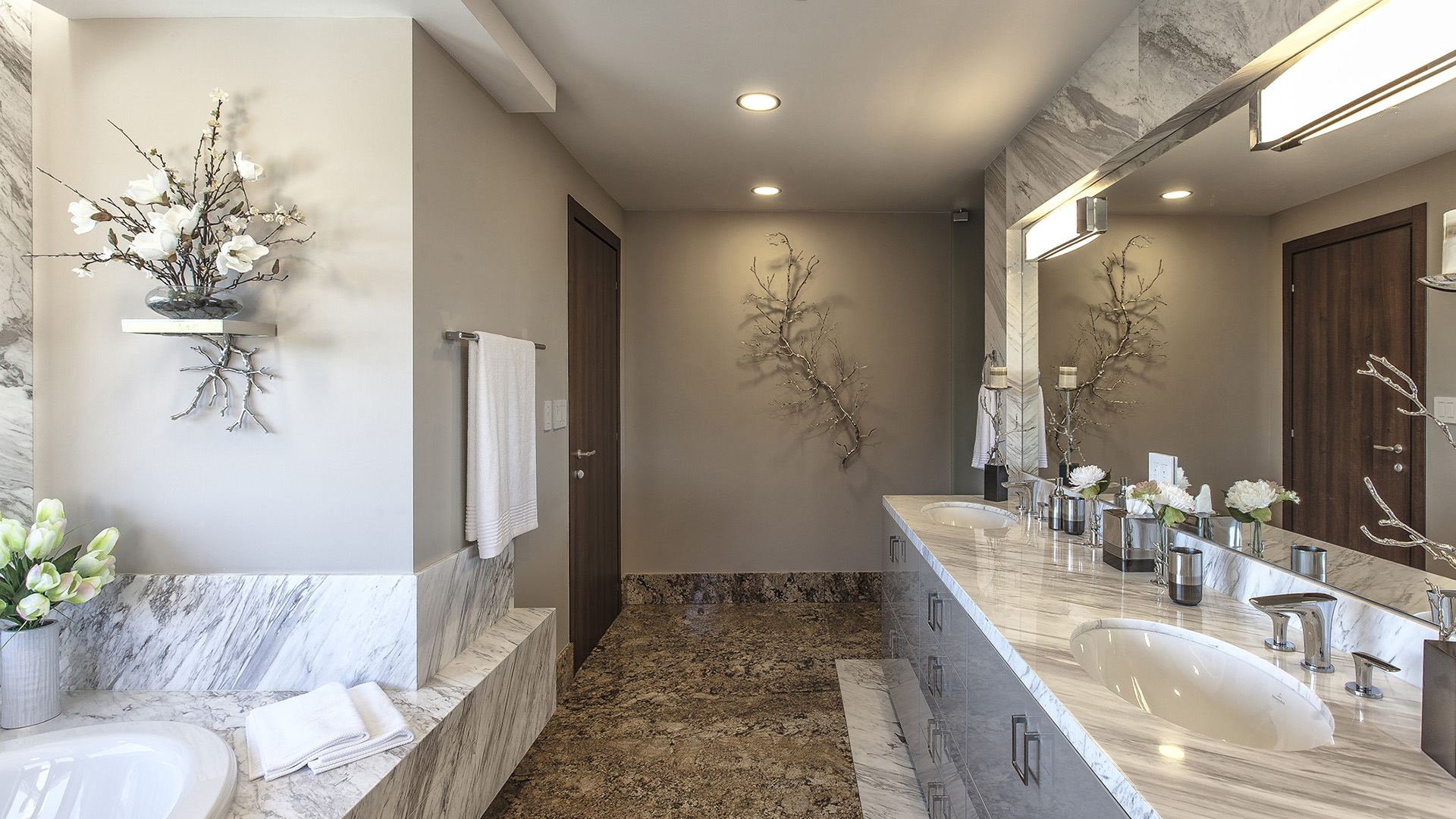 Master ensuite with Calacatta marble soaker tub surround dual undermount sinks polished marble vanity and designer chrome fixtures Millstream British Properties West Vancouver