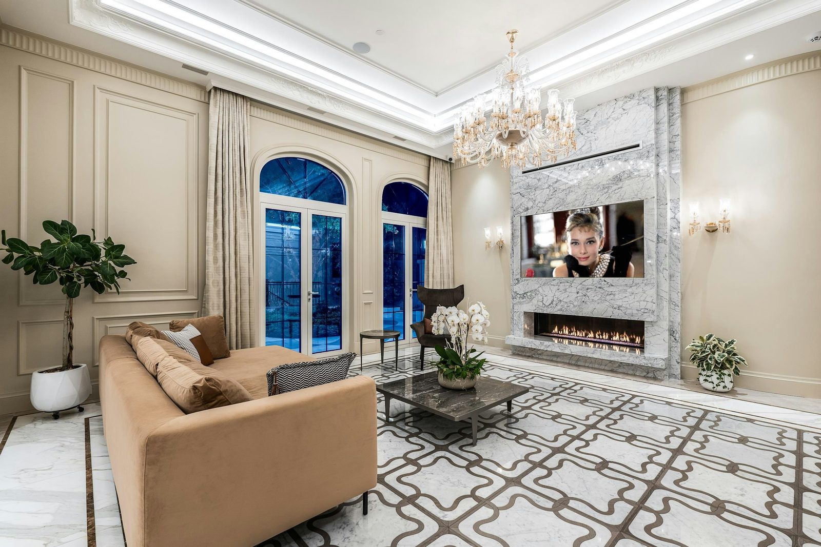 Wide view of formal living area with chandelier and arched French doors at Montbeau Eyremount
