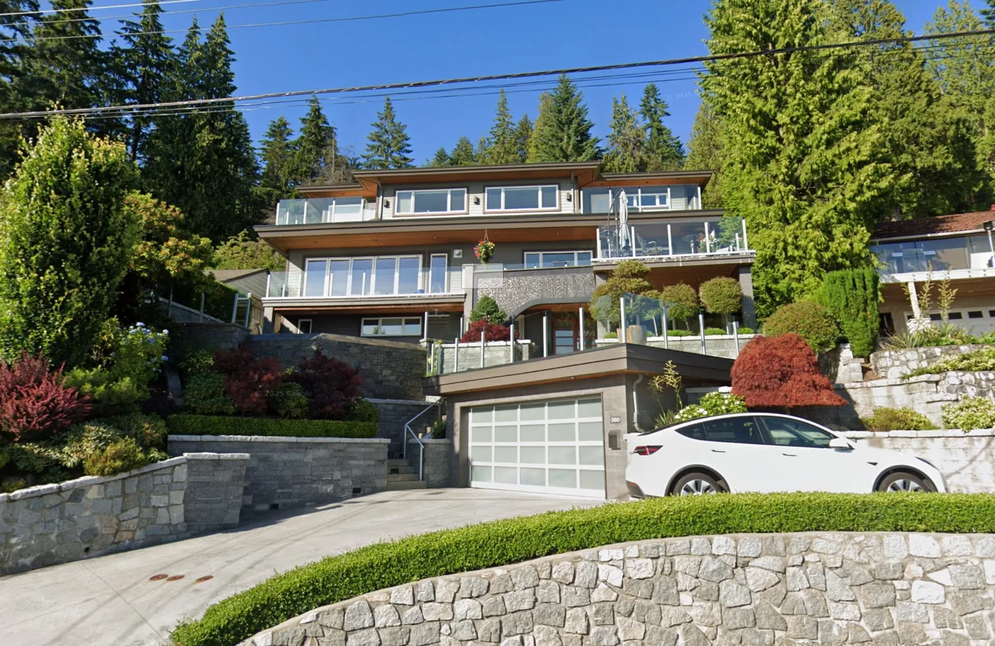 Multi-level North Vancouver building with several balcony decks and glass railings — balcony and envelope restoration by Eurohouse Construction