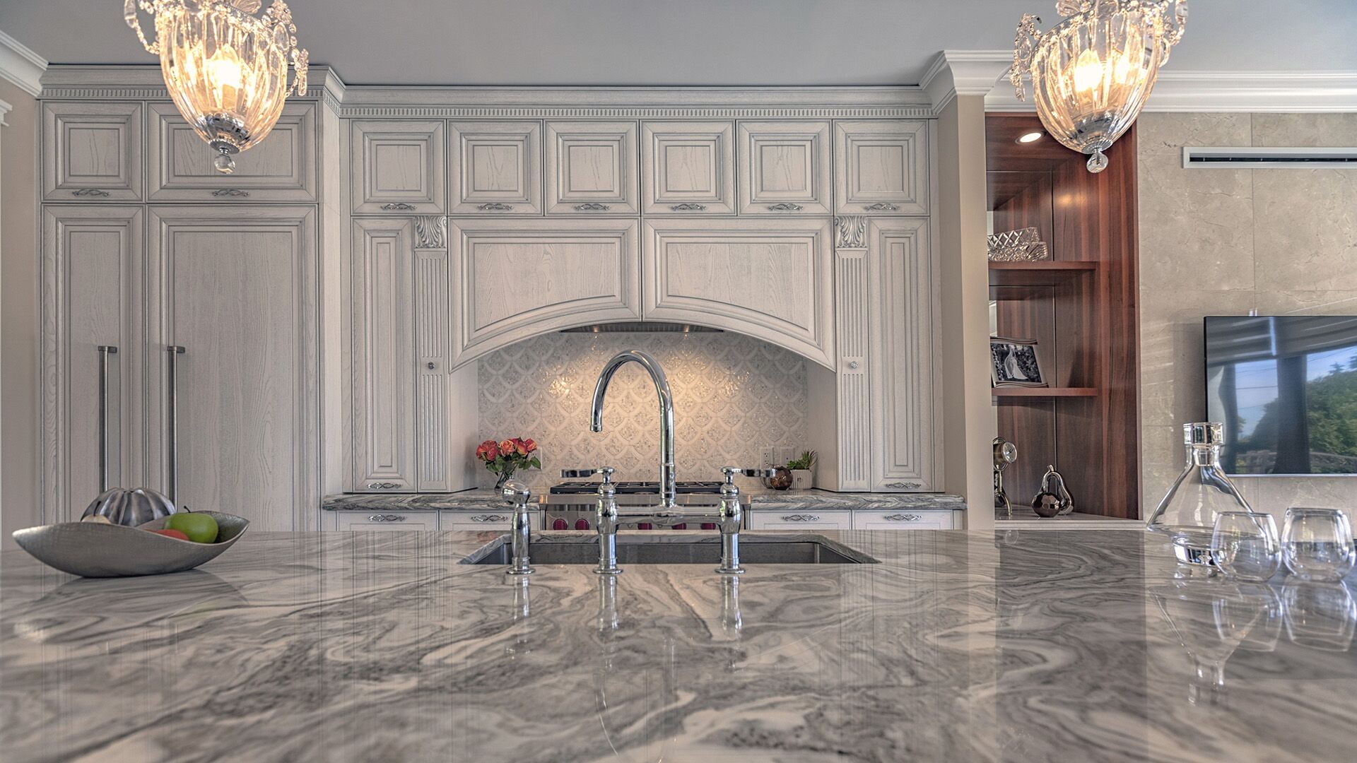 Classical Italian solid wood kitchen with veined marble countertops, crystal chandeliers, and arabesque mosaic backsplash designed and installed by Eurohouse Construction in West Vancouver