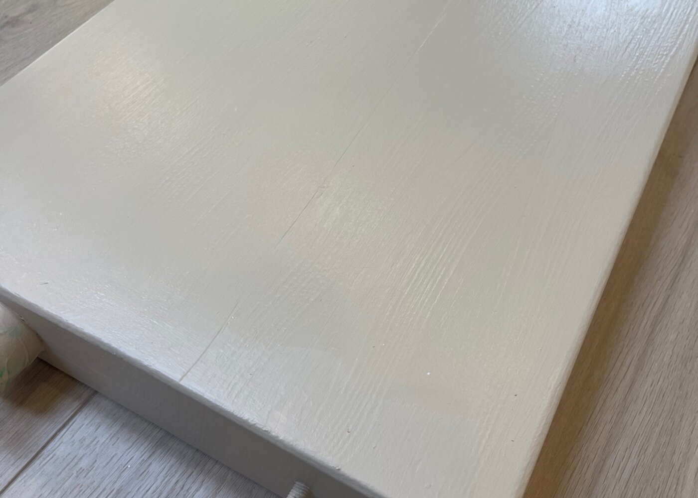 Close-up of plywood platform constructed under kitchen cabinets to protect floating floor from being pinned during insurance restoration