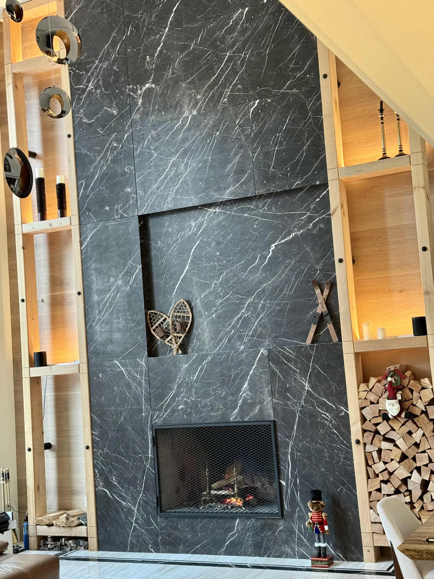 Italian-marble double-height fireplace in the Rainbow Whistler custom home by Eurohouse
