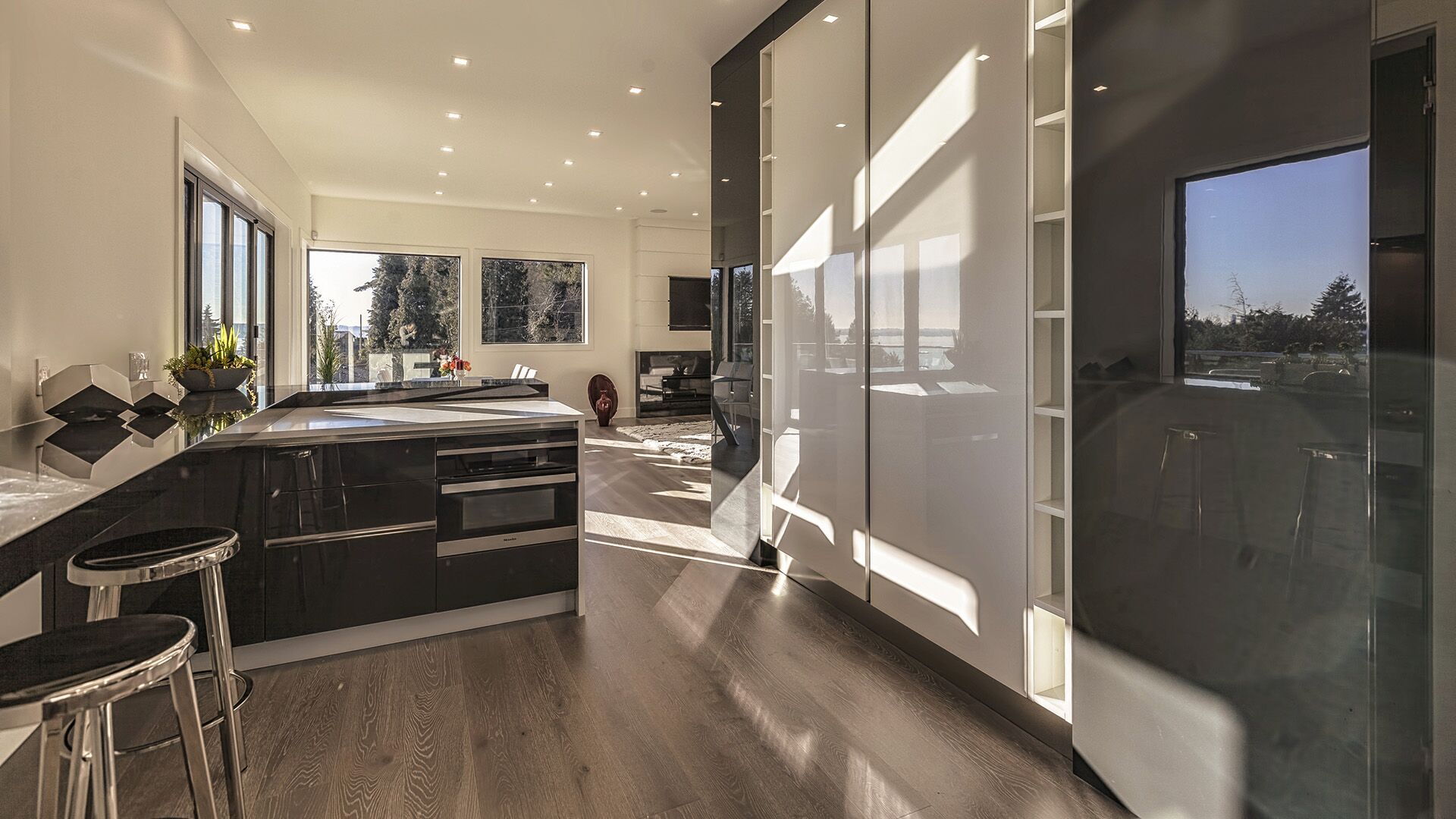 Italian millwork kitchen with Miele appliances, bar seating, and floor-to-ceiling pantry storage, designed and installed by Eurohouse Construction in West Vancouver