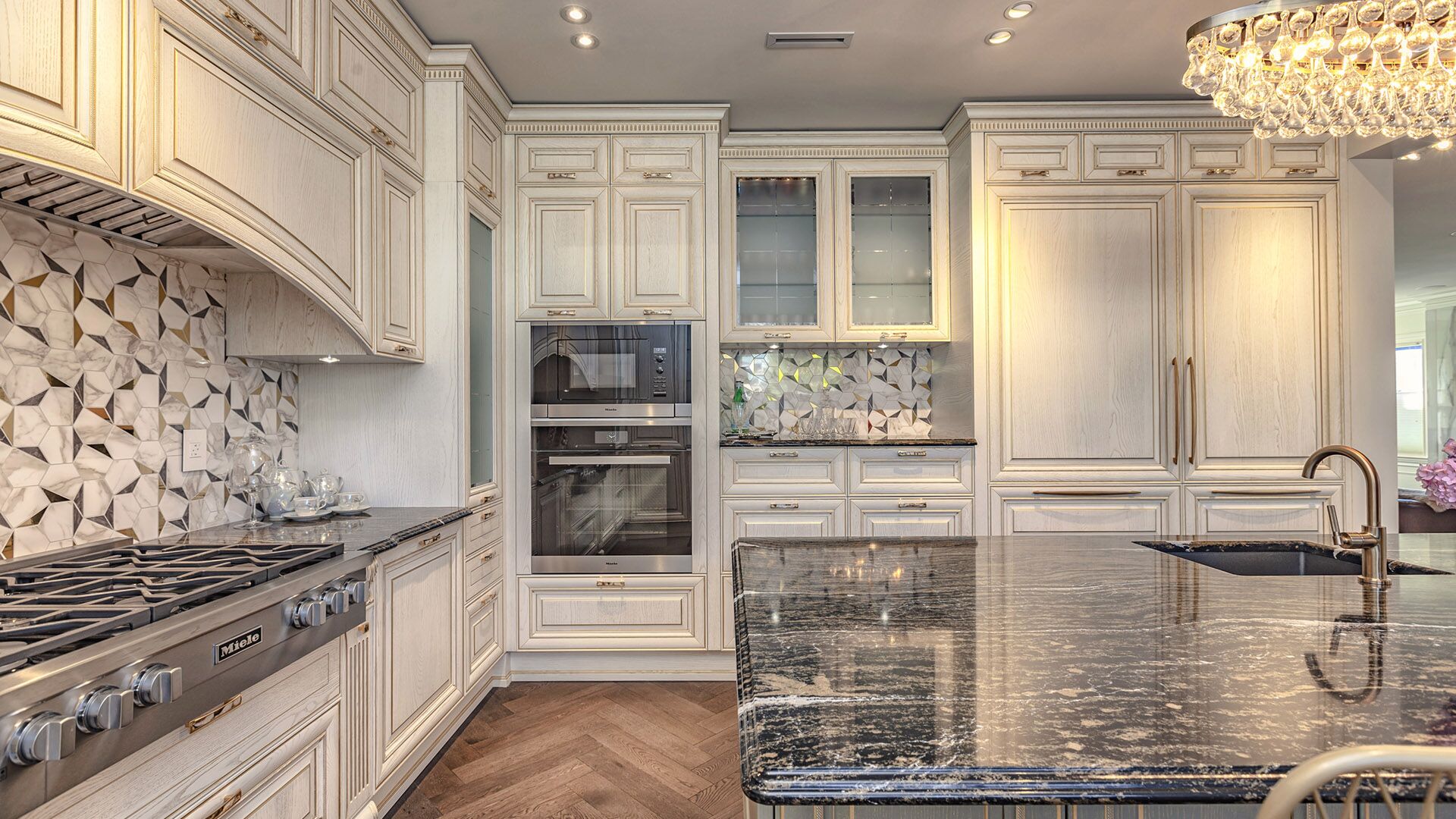 Italian classical kitchen showing Miele range, double oven, cathedral arch hood, and dark granite island countertop by Eurohouse Construction West Vancouver