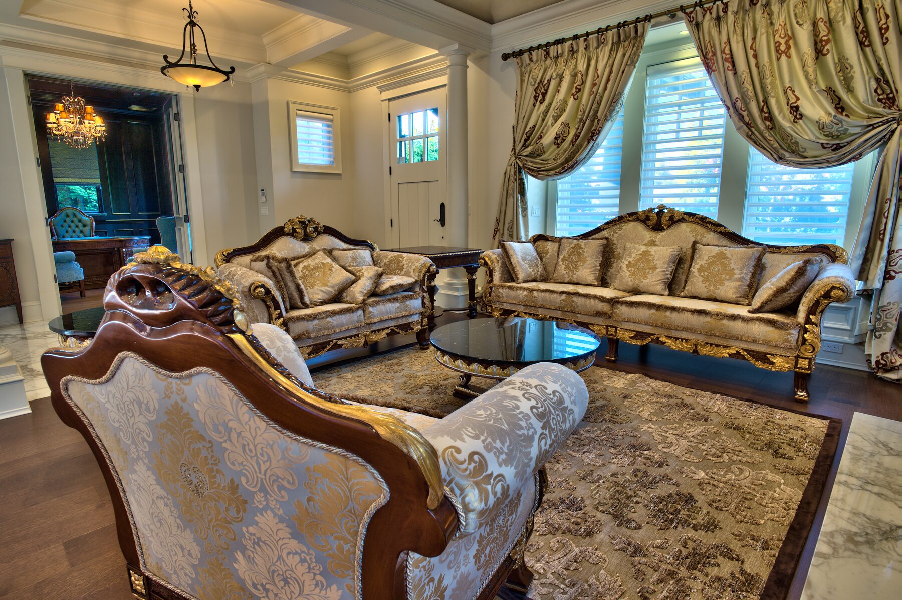 Carved Francesco Molon settee and side chairs in an entry hall beside the front door of a Vancouver home furnished by Eurohouse Construction
