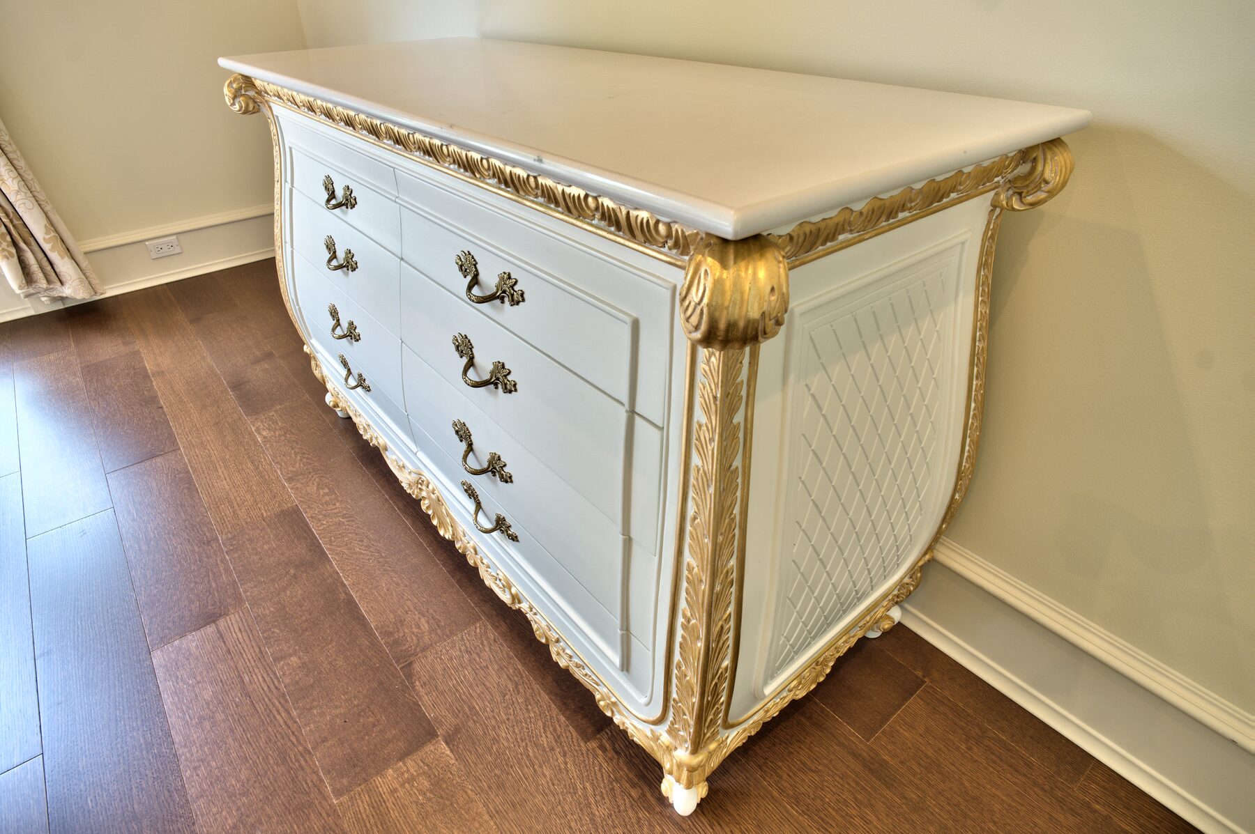 Painted and gold leafed Francesco Molon chest of drawers with carved apron and gilded feet in a Vancouver home furnished by Eurohouse Construction