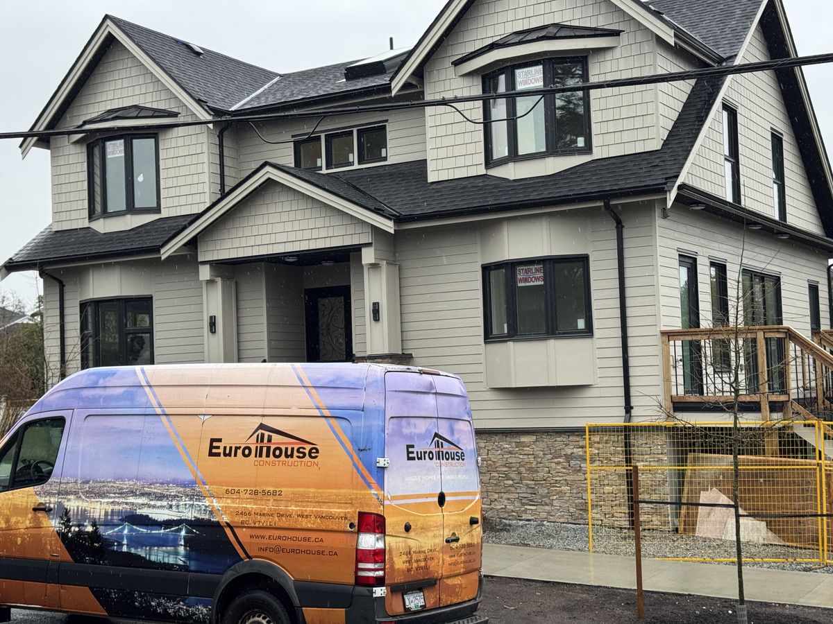Completed exterior with Eurohouse Construction branded van — fire damage full rebuild Vancouver