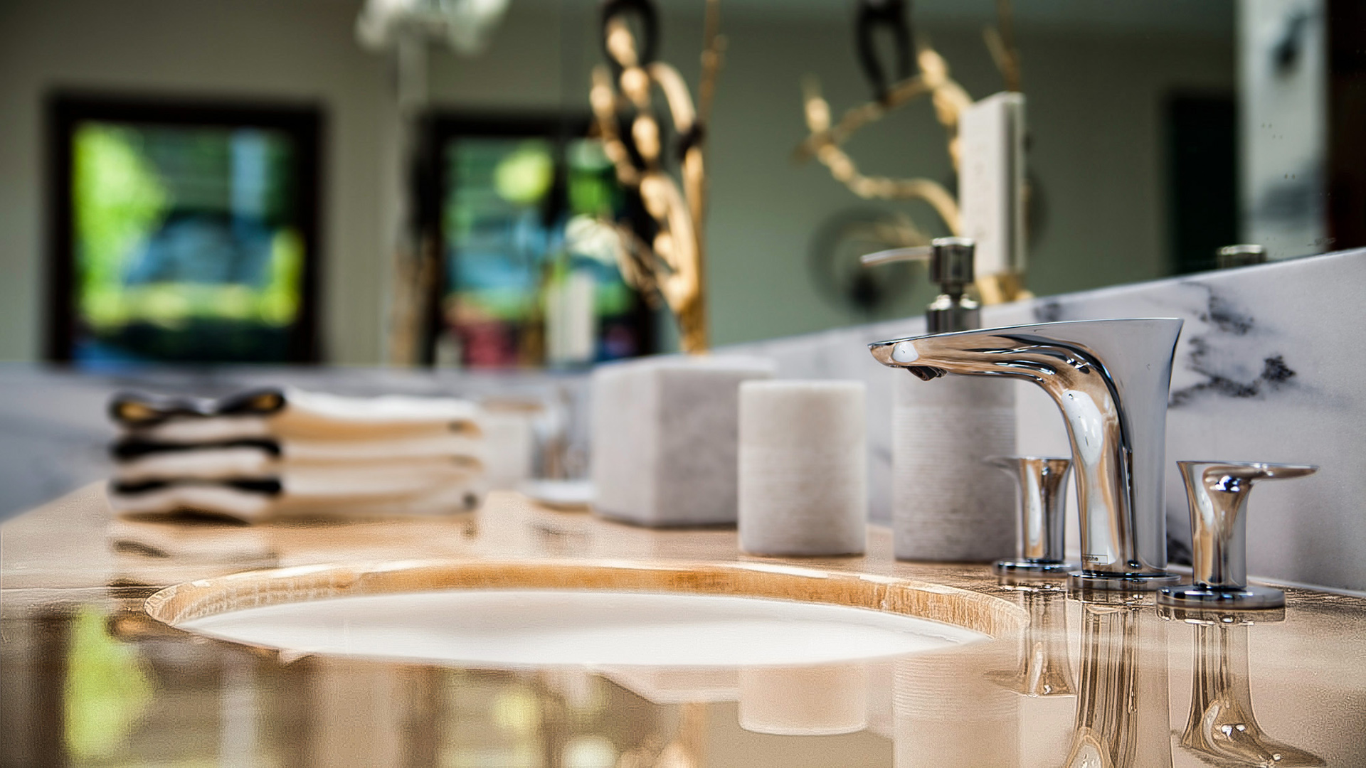 Close-up of polished onyx vanity countertop with designer chrome faucet in master ensuite West Bay West Vancouver
