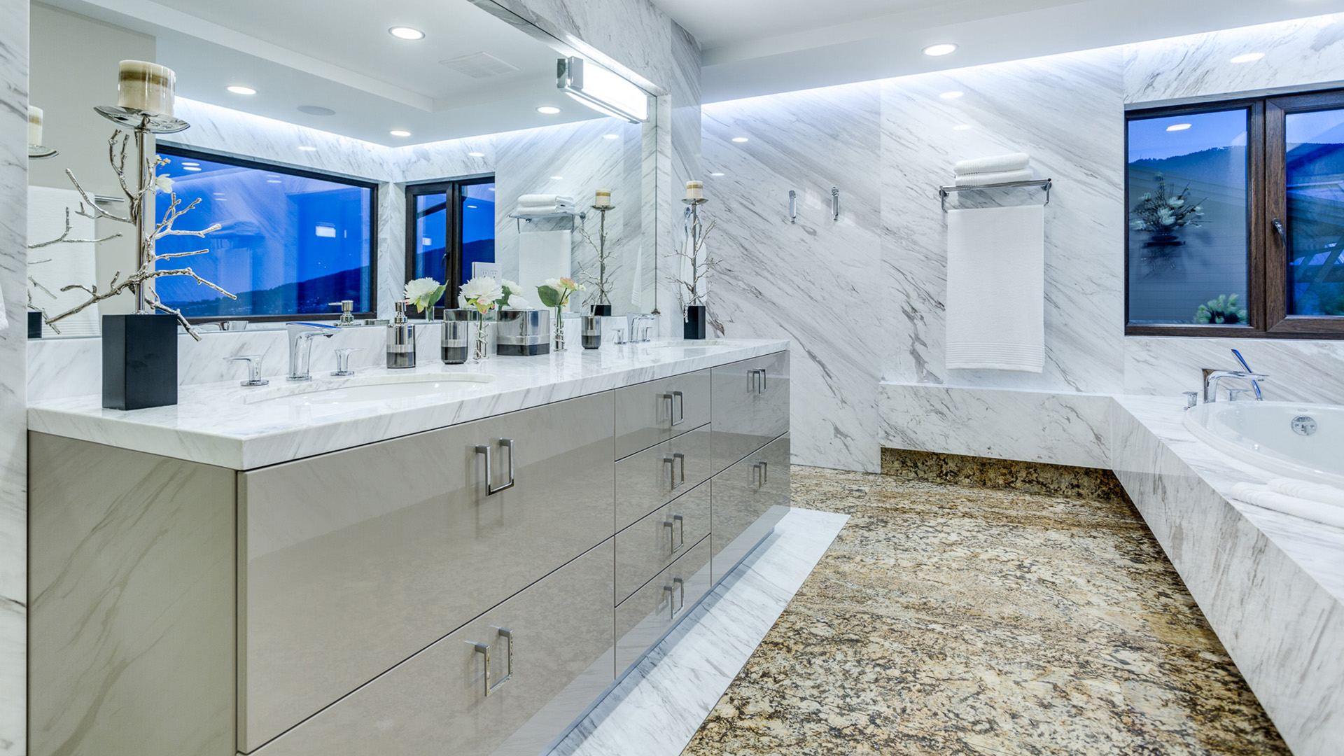 Master ensuite with marble walls Italian cabinetry Hansgrohe fixtures granite flooring and soaker tub with views West Coast Contemporary British Properties