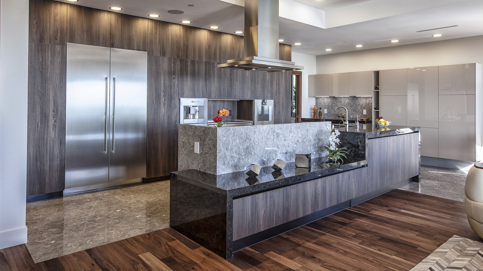 Kitchen detail showing Italian cabinets dual islands marble and granite counters Gaggenau coffee system and wok kitchen beyond West Coast Contemporary