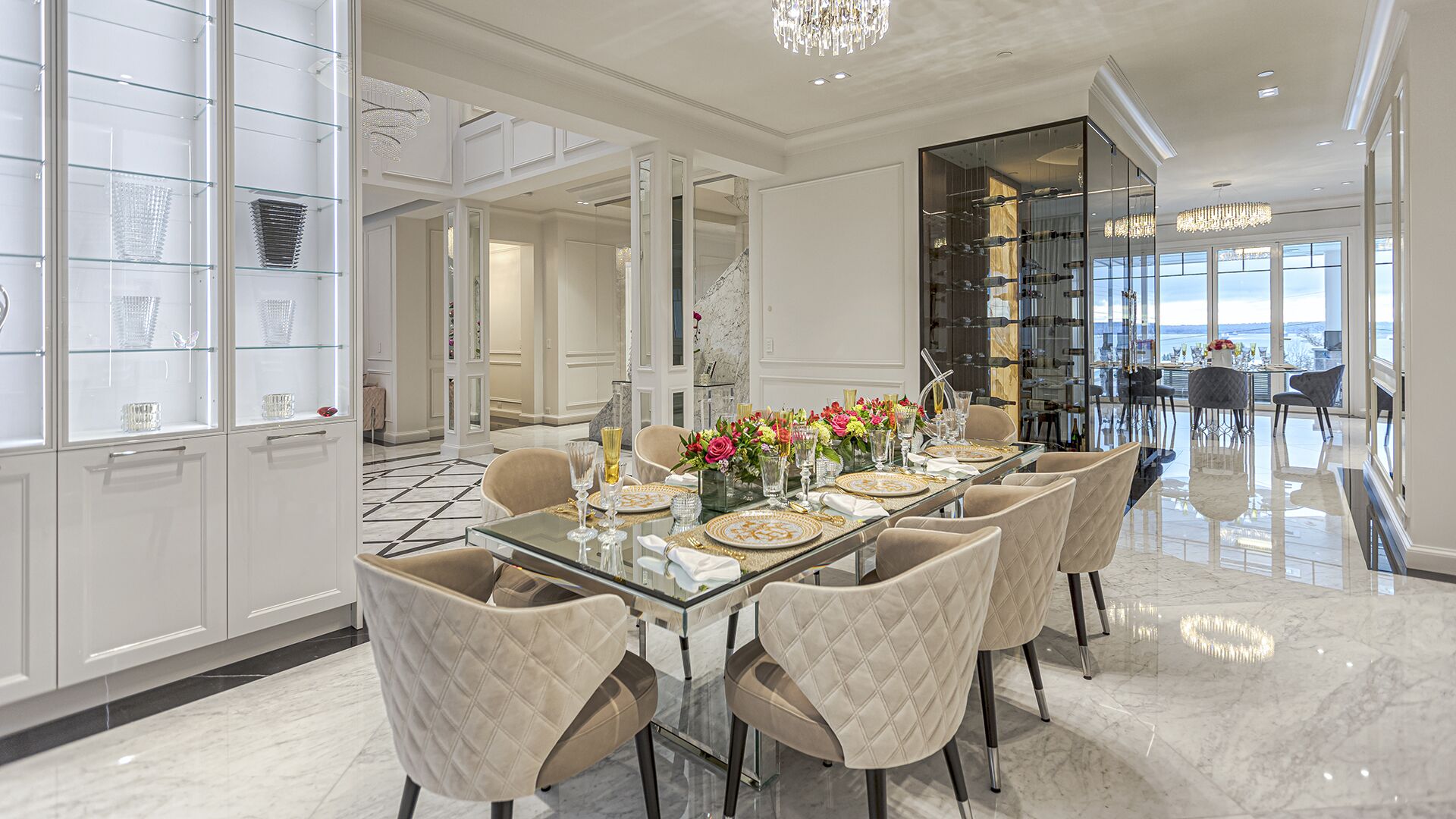 Formal dining room with crystal display cabinet glass table wine display tower and Italian marble floor West Vancouver luxury home Eurohouse