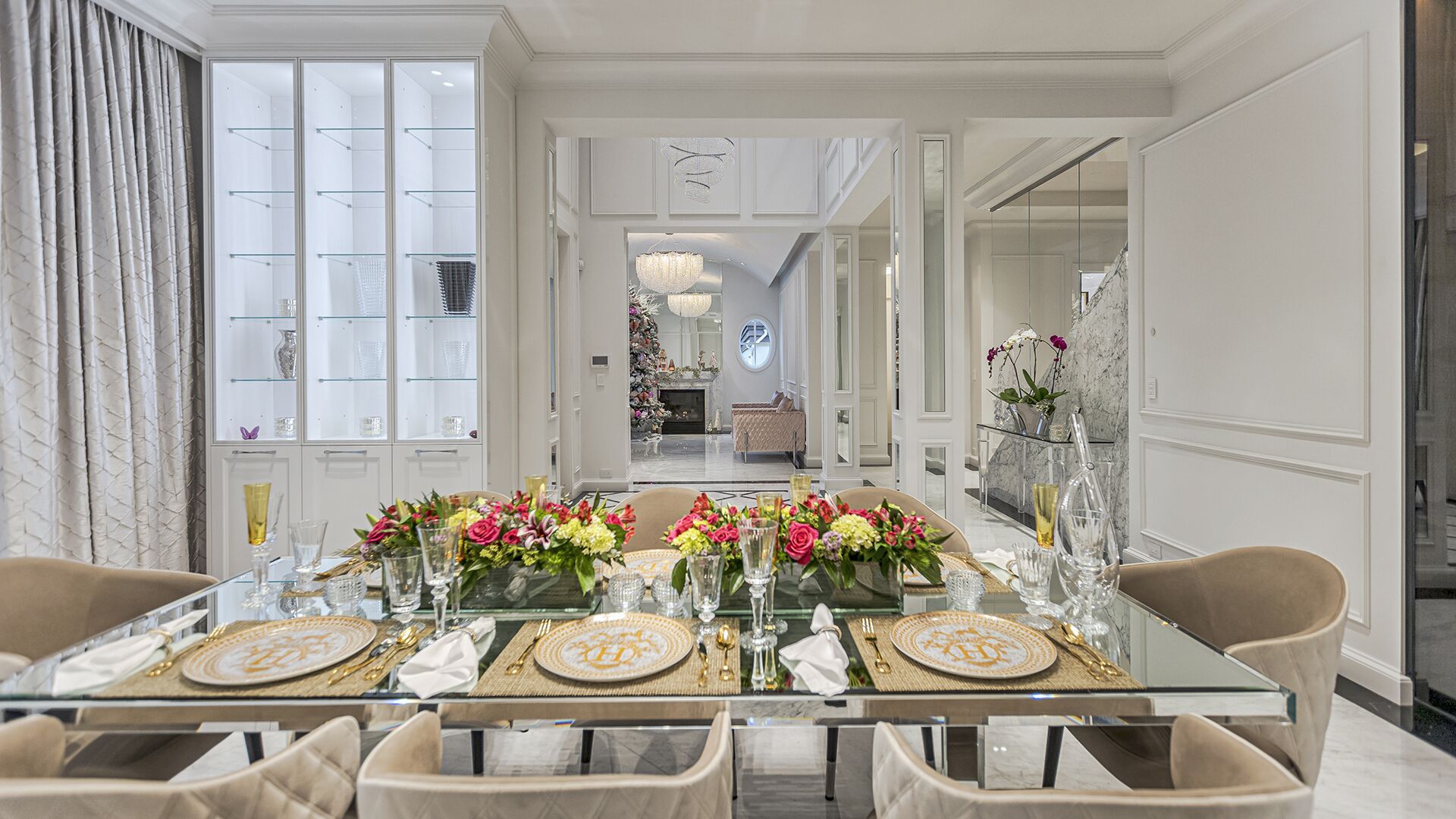 Dining room opposite angle with crystal chandelier wainscoting and view through to living room West Vancouver home by Eurohouse Construction