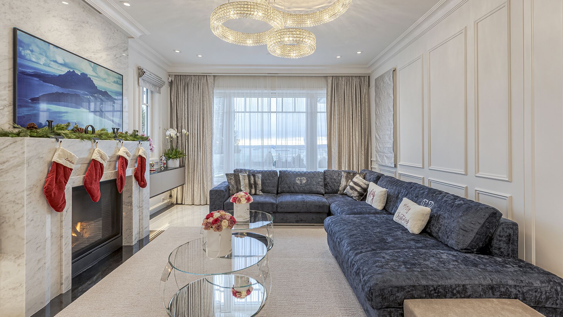 Family room with blue velvet sectional marble fireplace and interlocking crystal chandelier West Vancouver meets Manhattan Eurohouse Construction